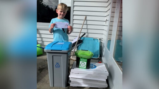 Boy with recycling bins.